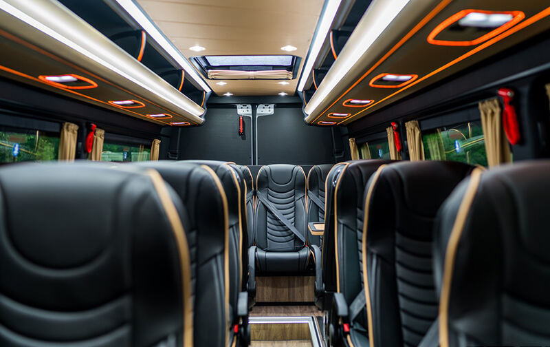 Executive Sprinter cabin with black leather seats and ceiling lights