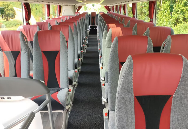Aisle and red-and-gray seats in a Setra double-deck coach